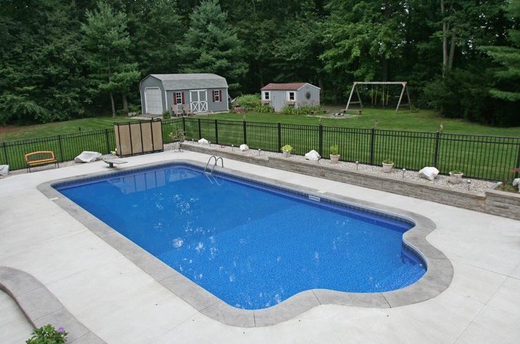 This is a photo of a patrician in ground pool in Saugerties, NY diving board and fence in backyard.