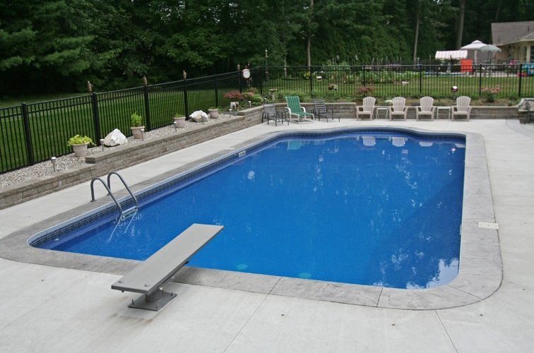 This is a photo of a patrician in ground pool in Saugerties, NY with chairs and fence in backyard.