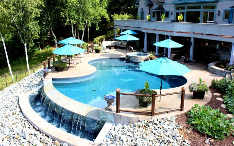 Custom pool with overflow waterfall installed by Majestic Pools