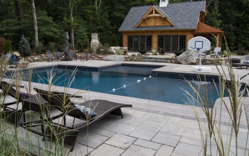 This is a photo of a patrician in ground pool with custom pool house.