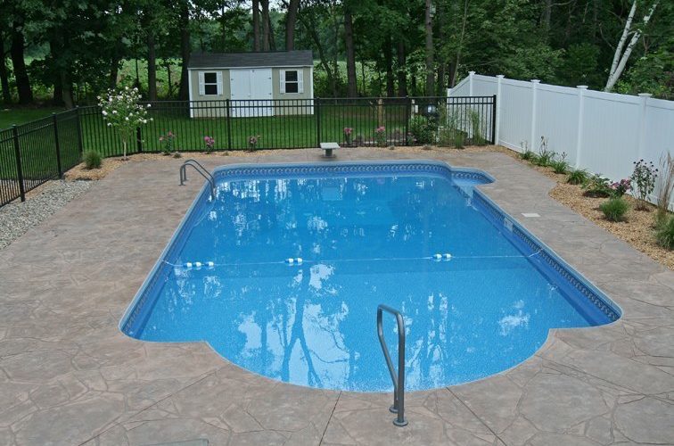 This is a photo of a patrician in ground pool with custom pavers.