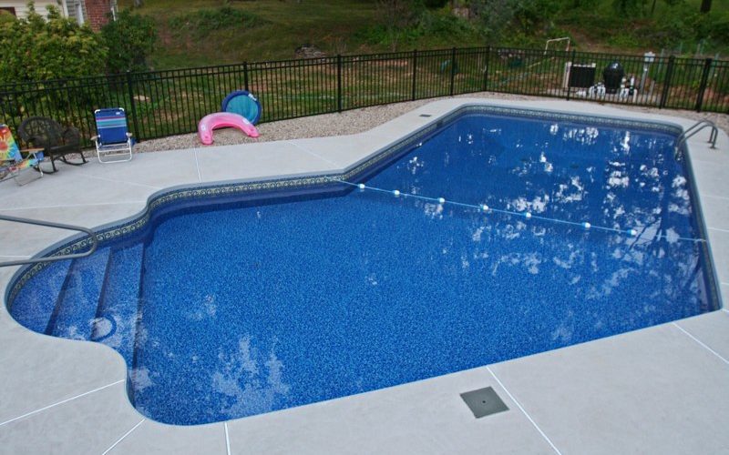 This is a photo of a Lazy L style custom inground swimming pool installed by julianos
