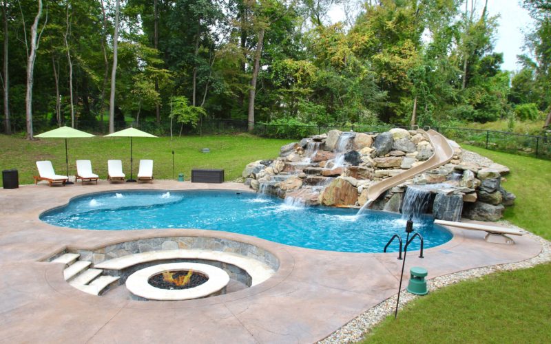 Custom inground pool with slide installed by Majestic Pools