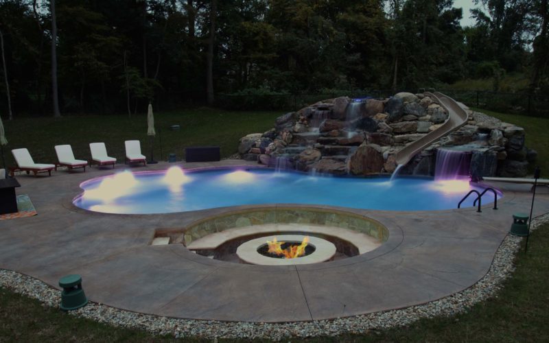 Night lit custom inground pool installed by Majestic Pools
